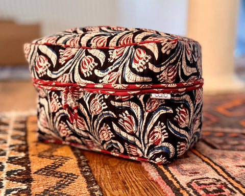 vanity wash bag in black, red and blue arts and craft style floral print with contrast trim and quilt stitching