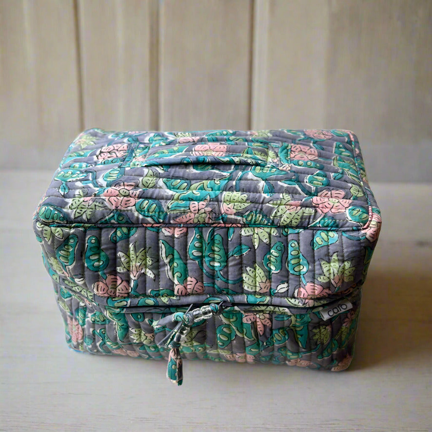 blue, pink and green floral print washbag with carry handle on top made by caro london