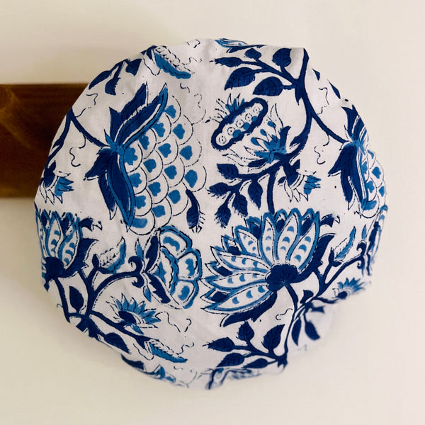 Blue and white large scale floral print cotton bath hat hanging on the bathroom wall
