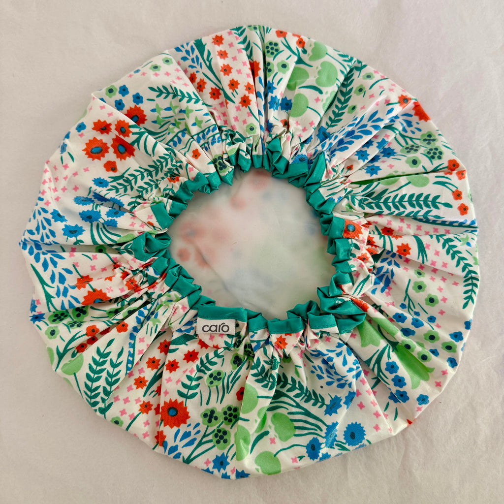 overhead photo of inside of best selling Clara print turquoise, orange, green and white floral waterproof cotton print shower cap