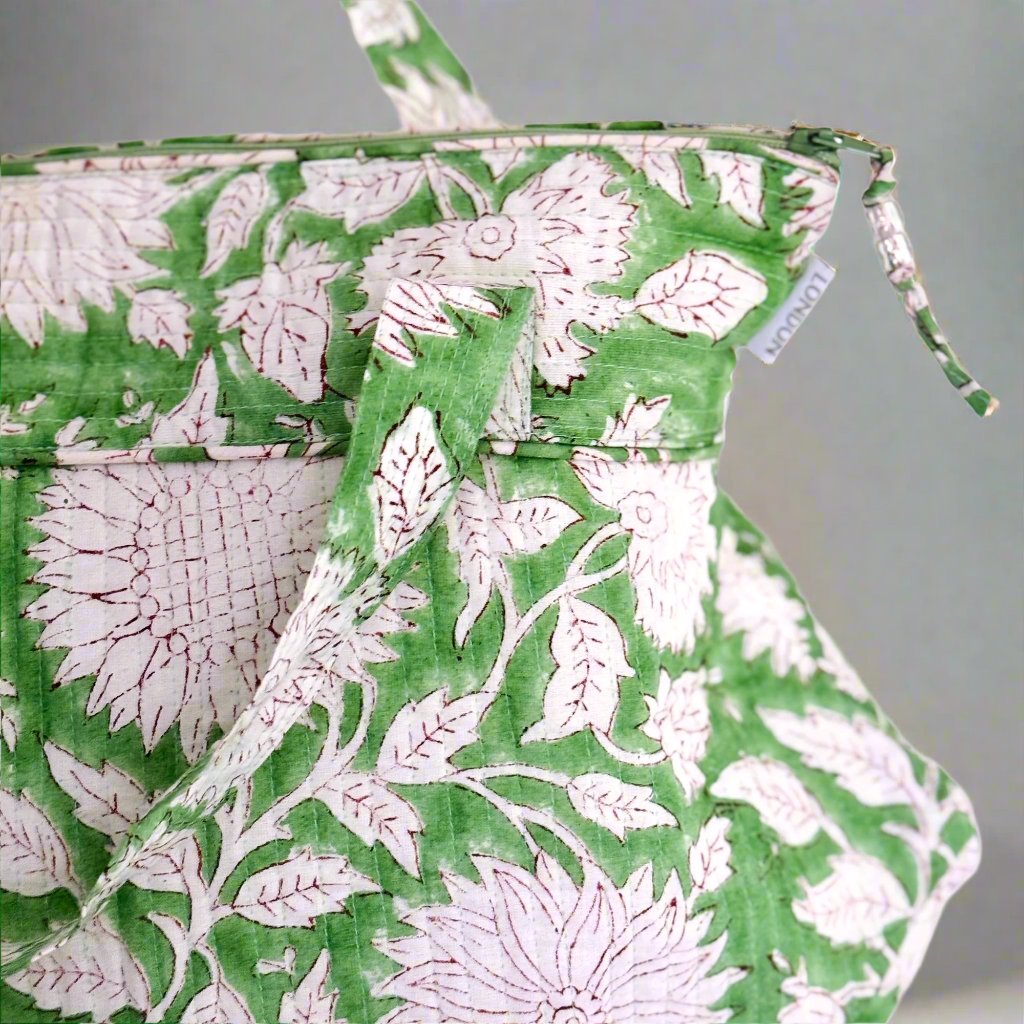 Close up of washbag in green and white sunflower print 