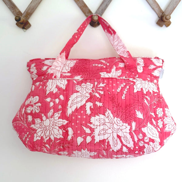 pink and white stencil floral wash bag hanging on a peg