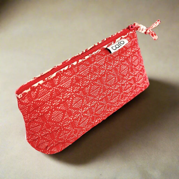 small red make up bag on shelf