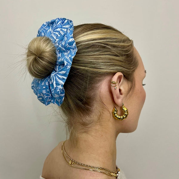 Close up of a girl wearing a blue floral cotton scrunchy in her hair