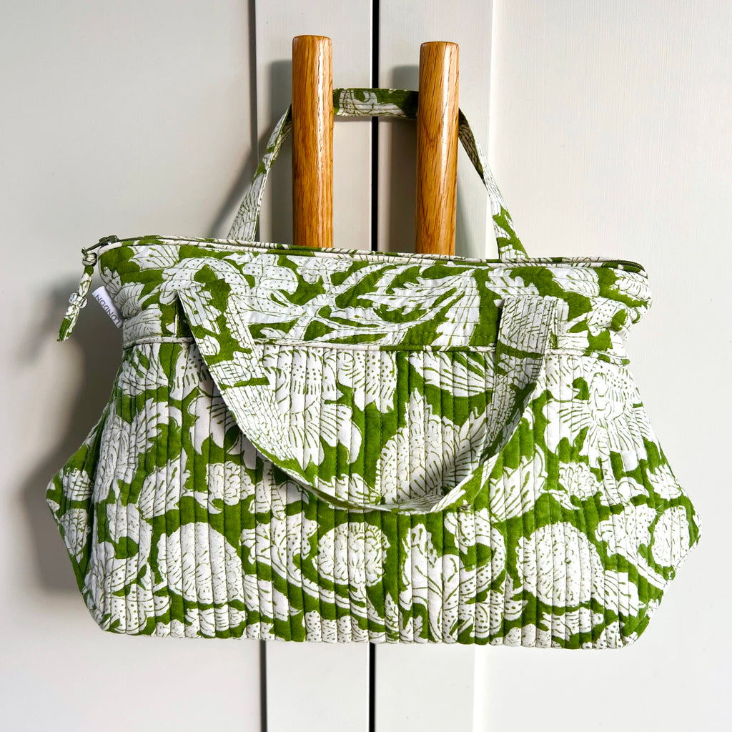 Caro Londons Tall wash bag with hanging handles in white floral print on emerald green ground. Has a water resistant lining.