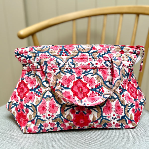 pink and white floral print quilted washbag with carrying handles by Caro London