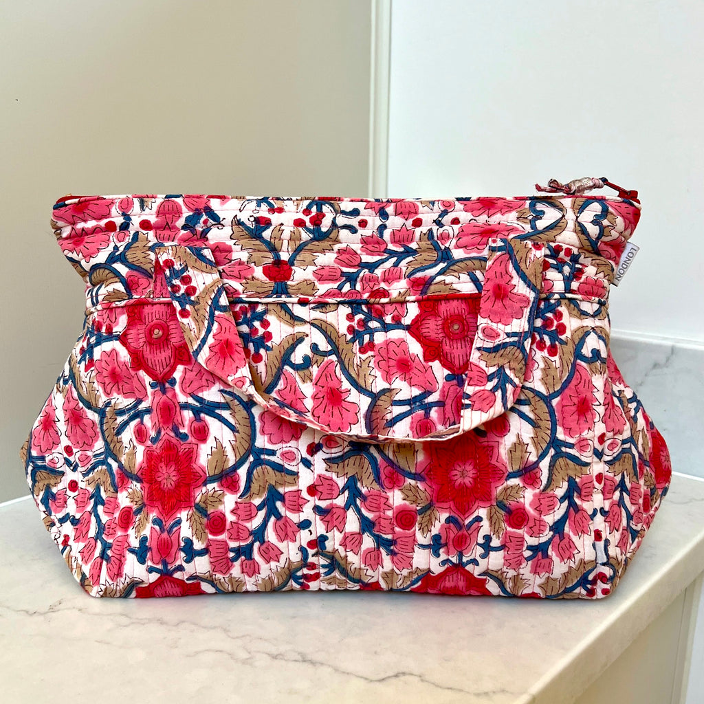 pink and white floral print quilted washbag with carrying handles by Caro London