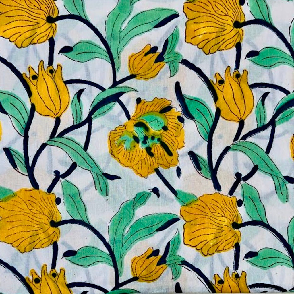 large scale floral print in yellow, black and green on white ground