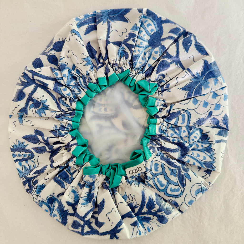 Inside view of Blue and white large scale floral waterproof shower cap with turquoise trim 