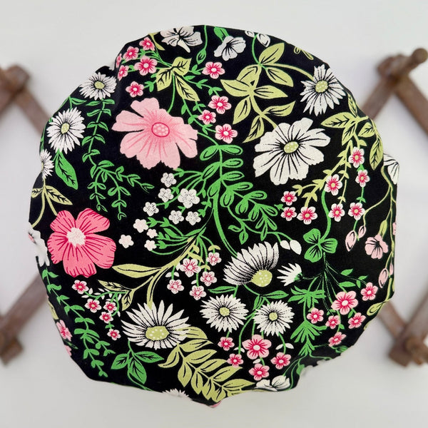 black orchard floral bath hat handing on a peg