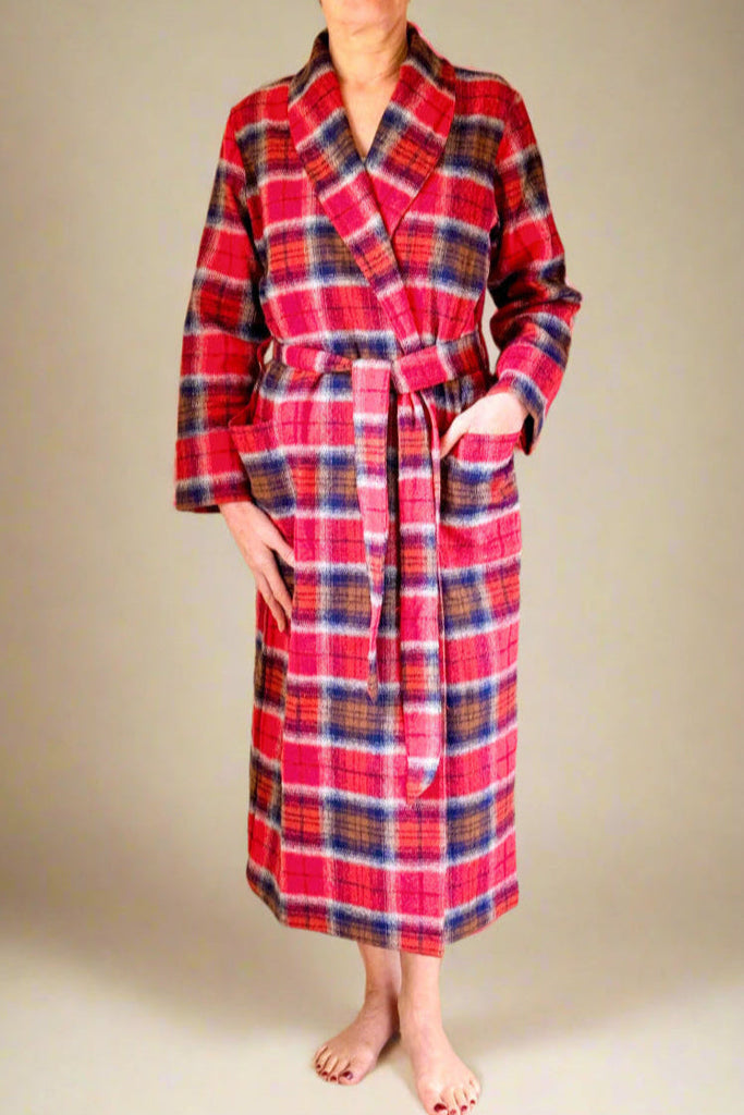 woman in a red, blue and brown check winter dressing gown with shawl collar and patch poclets