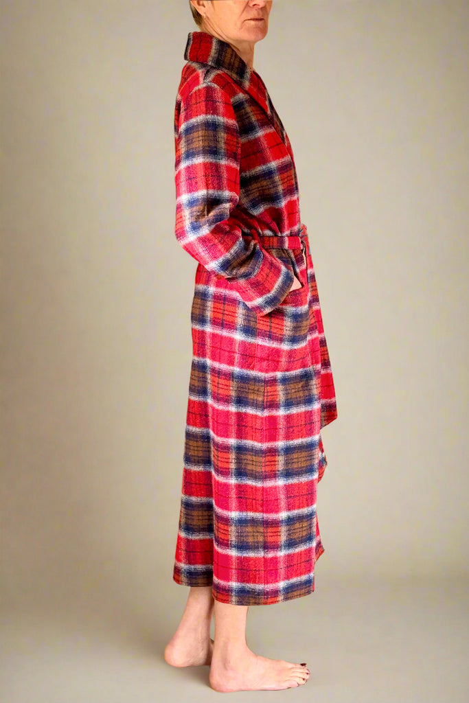 side view of woman in a red, blue and brown check winter dressing gown