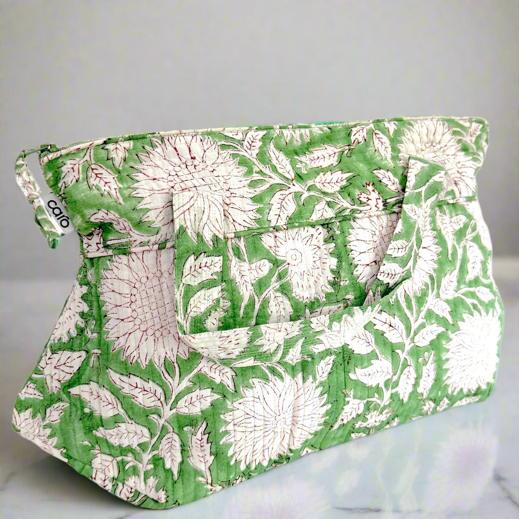 side view of washbag with handles in green and white sunflower print 