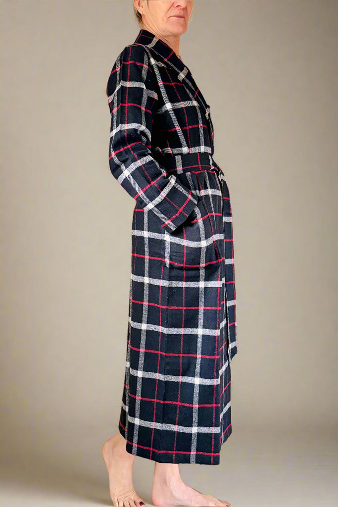 back view of woman wearing black, white and red windowpane checked dressing gown