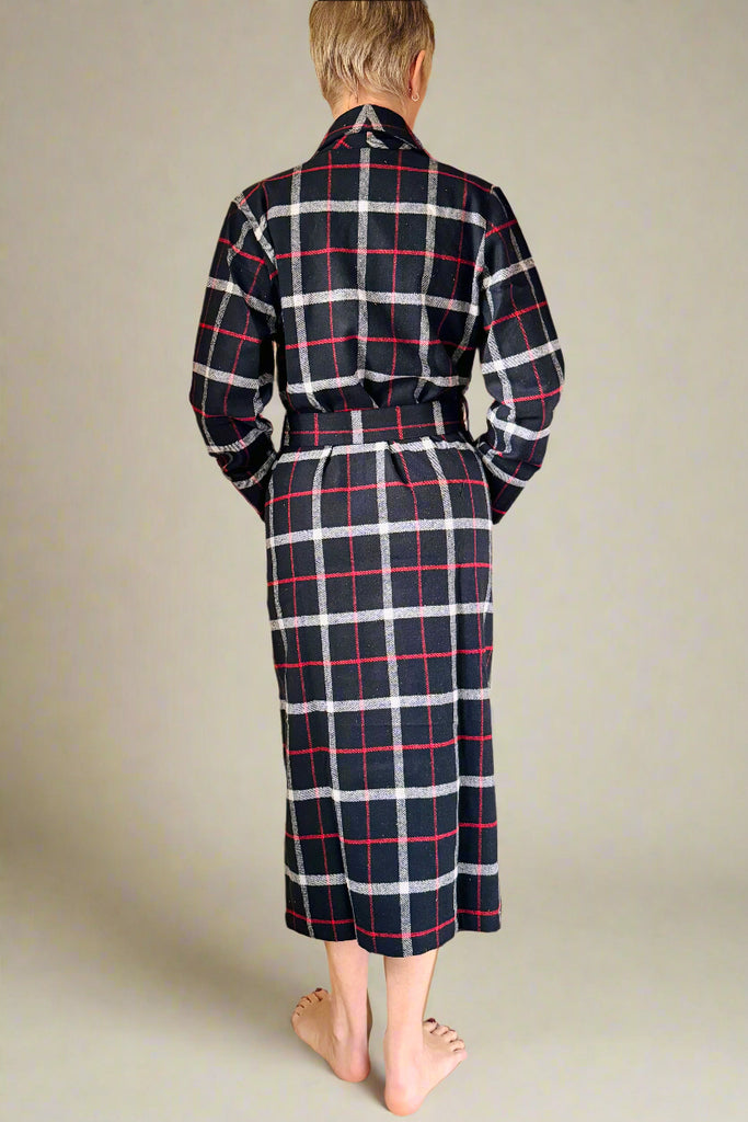 back view of woman wearing black, white and red windowpane checked dressing gown