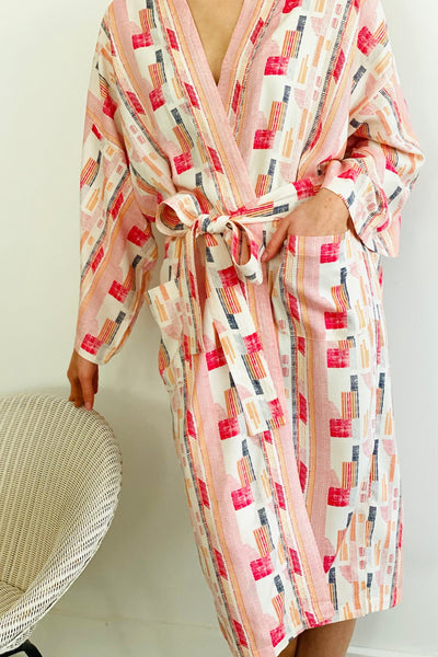 close up of geometric print red,pink and white kimono with pocket and belt