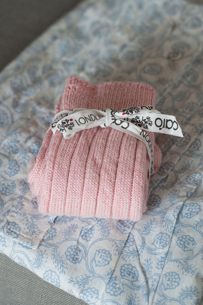 Pair of folded pink bedsocks tied with a ribbon